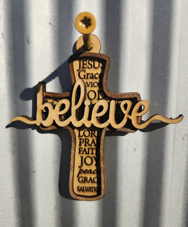 Wooden cross with engraved text on a corrugated metal background