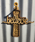 Wooden cross with engraved text on a corrugated metal background