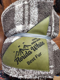 Green award plaque with 'Florida White Best Fur' text on a textured surface