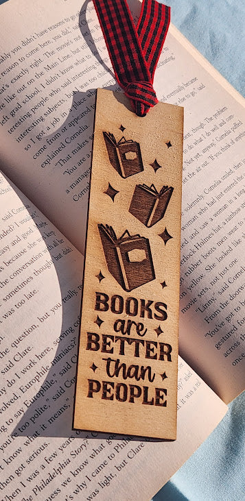 Wooden bookmark with 'Books are Better than People' text on an open book