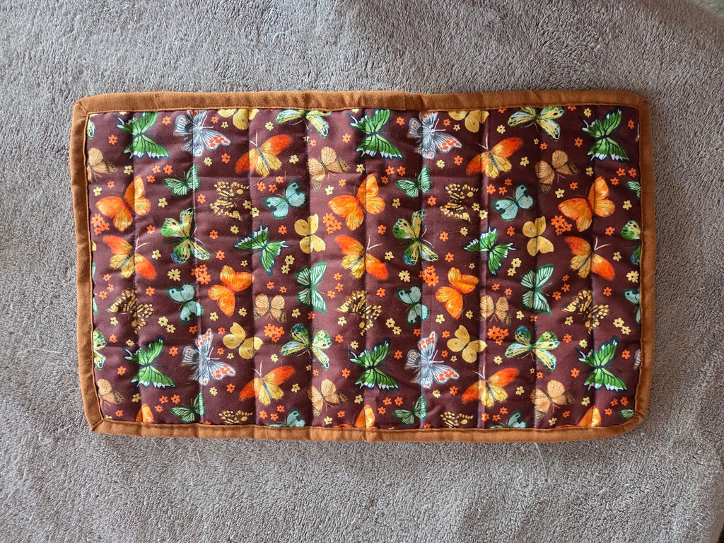 Fabric with butterfly pattern on a brown background