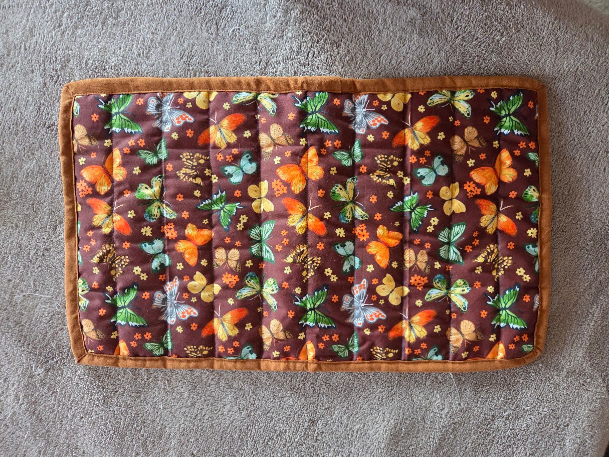 Fabric with butterfly pattern on a brown background