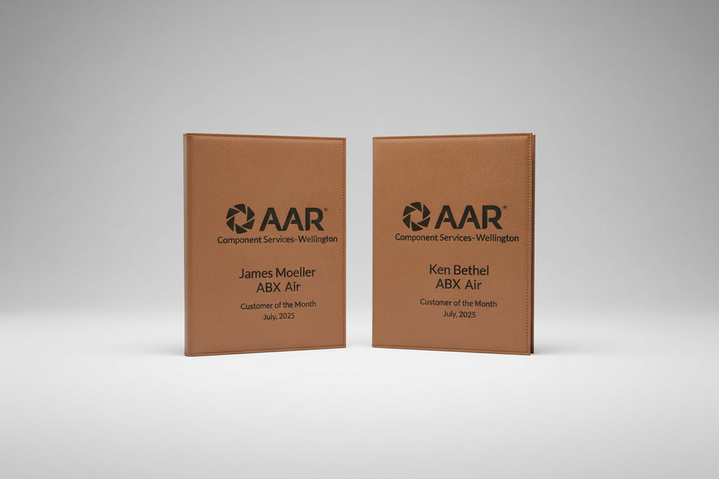 Two brown leather-bound awards for AAR Component Services-Wellington, 