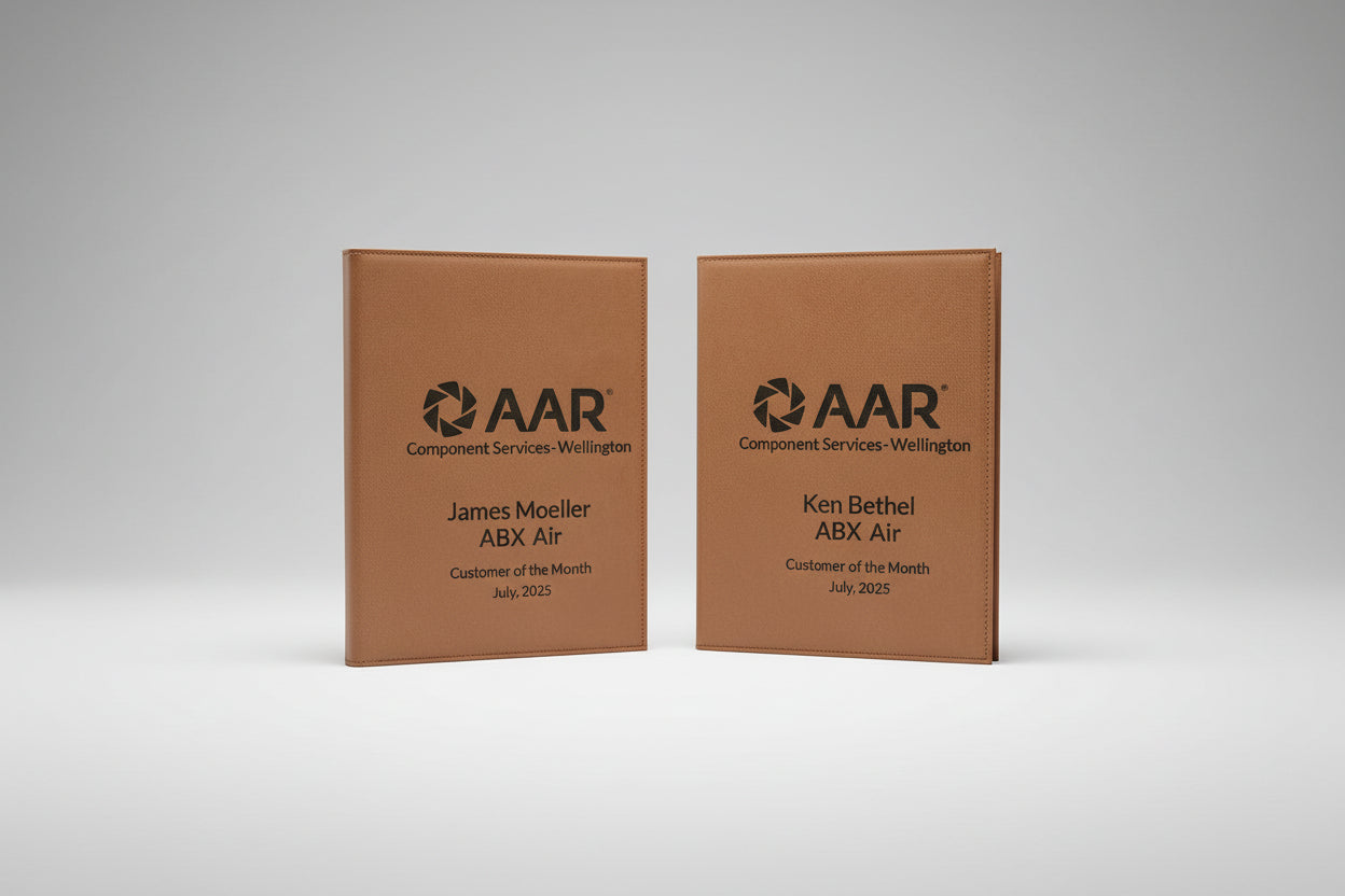 Two brown leather-bound awards for AAR Component Services-Wellington, 