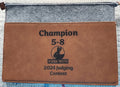 Brown leather pouch with 'Champion 5-8' and 'KSKRA Youth 2024 Judging Contest' text on a gray background
