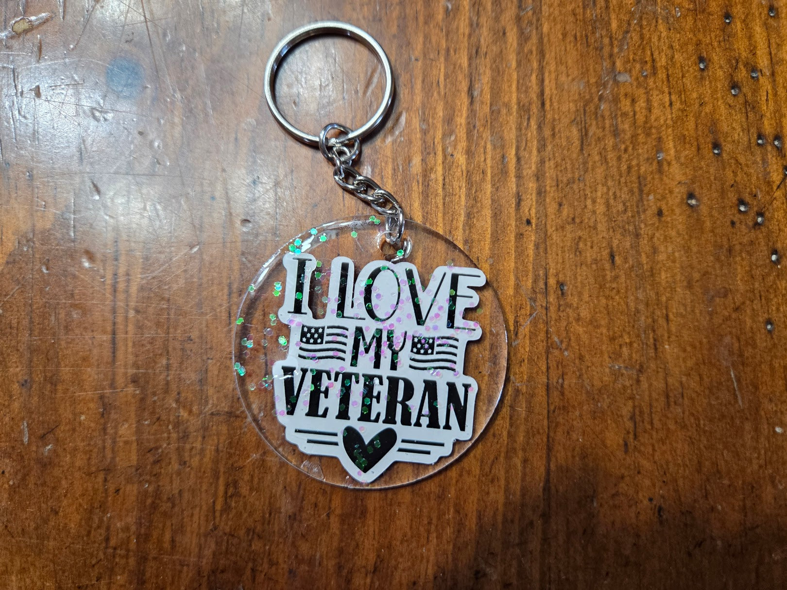 Keychain with 'I Love My Veteran' text on a wooden surface