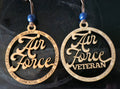 Pair of 'Air Force Veteran' ornaments with blue beads on a dark background