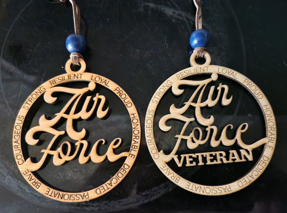 Pair of 'Air Force Veteran' ornaments with blue beads on a dark background