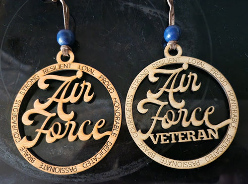 Pair of 'Air Force Veteran' ornaments with blue beads on a dark background