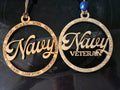Two round 'Navy' and 'Navy Veteran' pendants on a dark background.