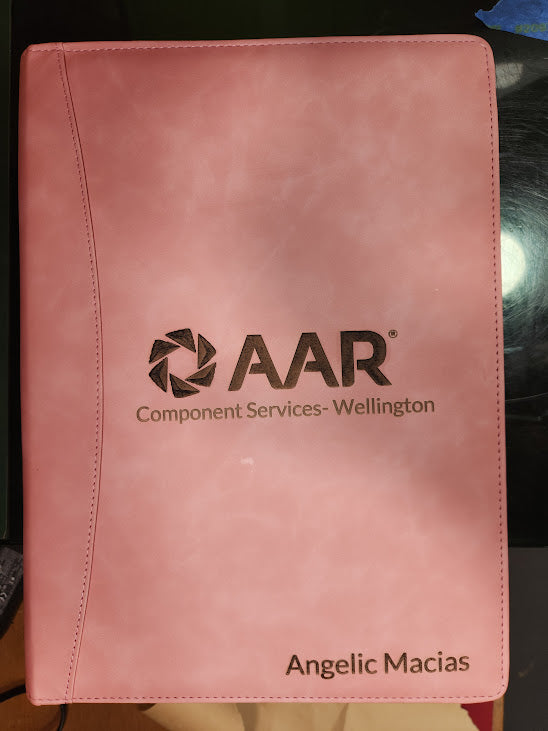 Pink folder with AAR logo and text on a dark background