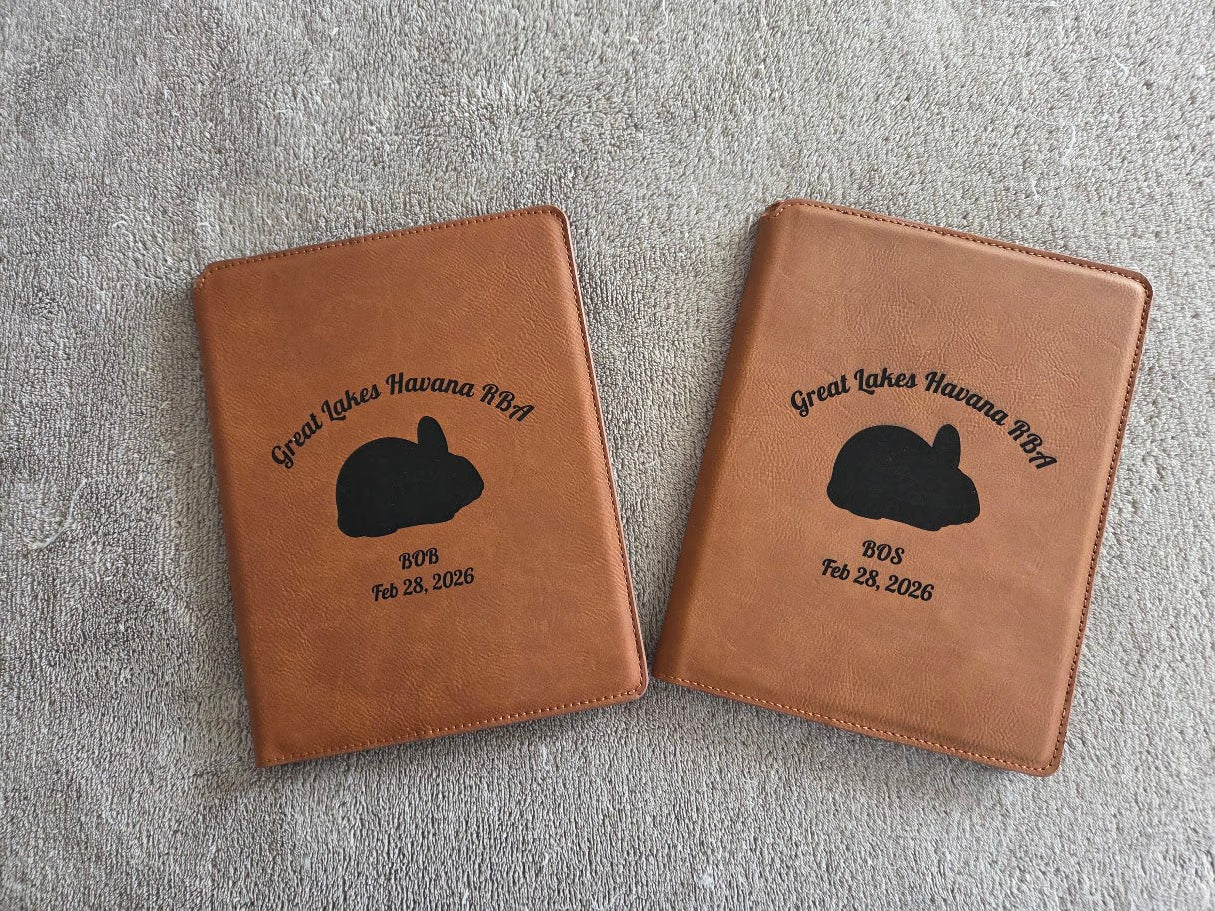 Two brown leather cases with  illustrations and text on a gray surface