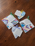 Small fabric bags with ribbons and cards on a wooden surface