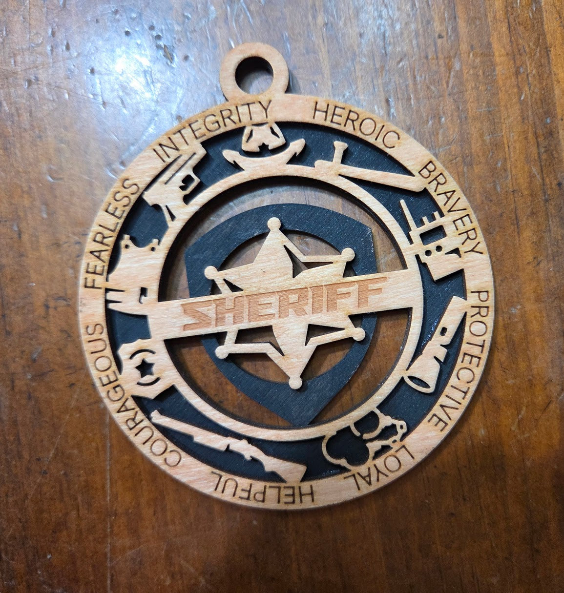 Wooden sheriff's badge ornament on a wooden surface