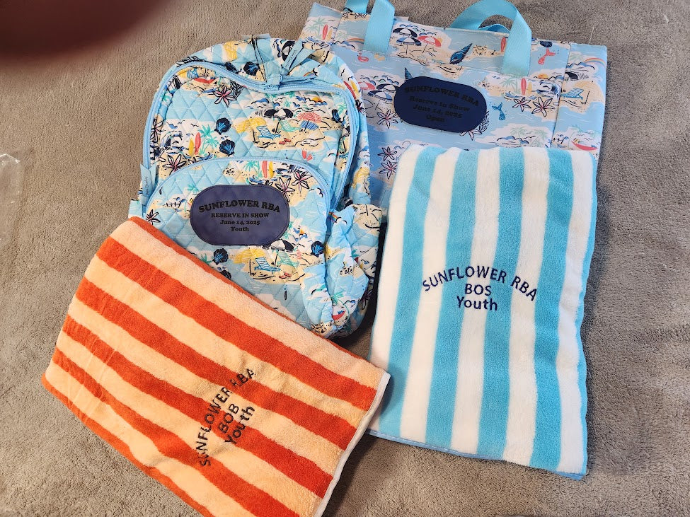 Set of bags and towels with 'Sunflower RBA' branding on a gray surface