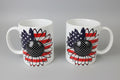 Two mugs with sunflower designs featuring American flag colors on a reflective surface.