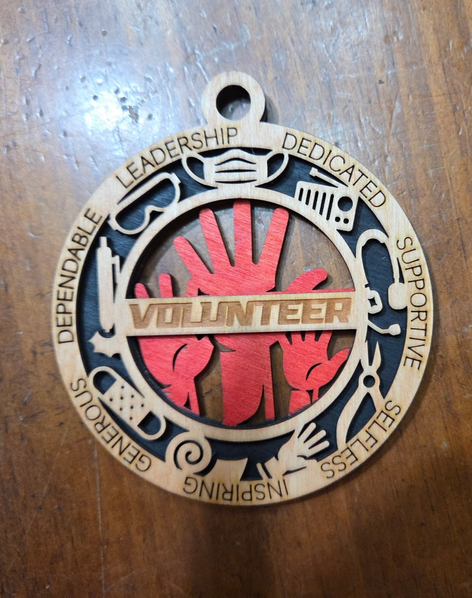 Medal with 'Volunteer' text and hands on a wooden background